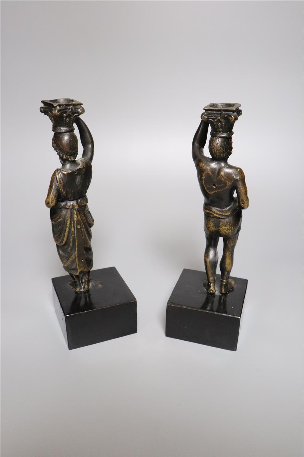 A pair of 19th century bronze figural candlesticks (once part of a clock), indistinctly stamped to reverse, overall height 23cm